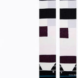 Limitations SB Sock - Pair of white socks with a black stripe at the top and a small red logo on the front.