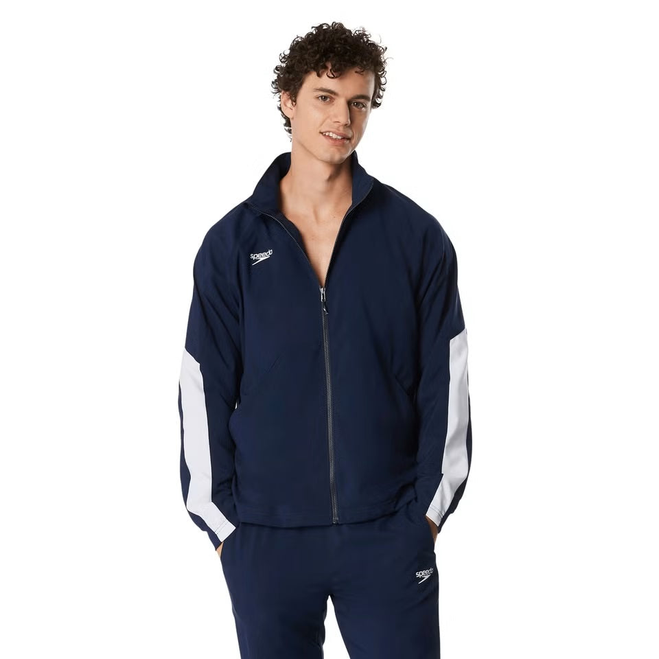 Speedo Men's Edge Warm Up Jacket - A navy blue jacket with a white logo on the left chest and two zippered pockets on either side.