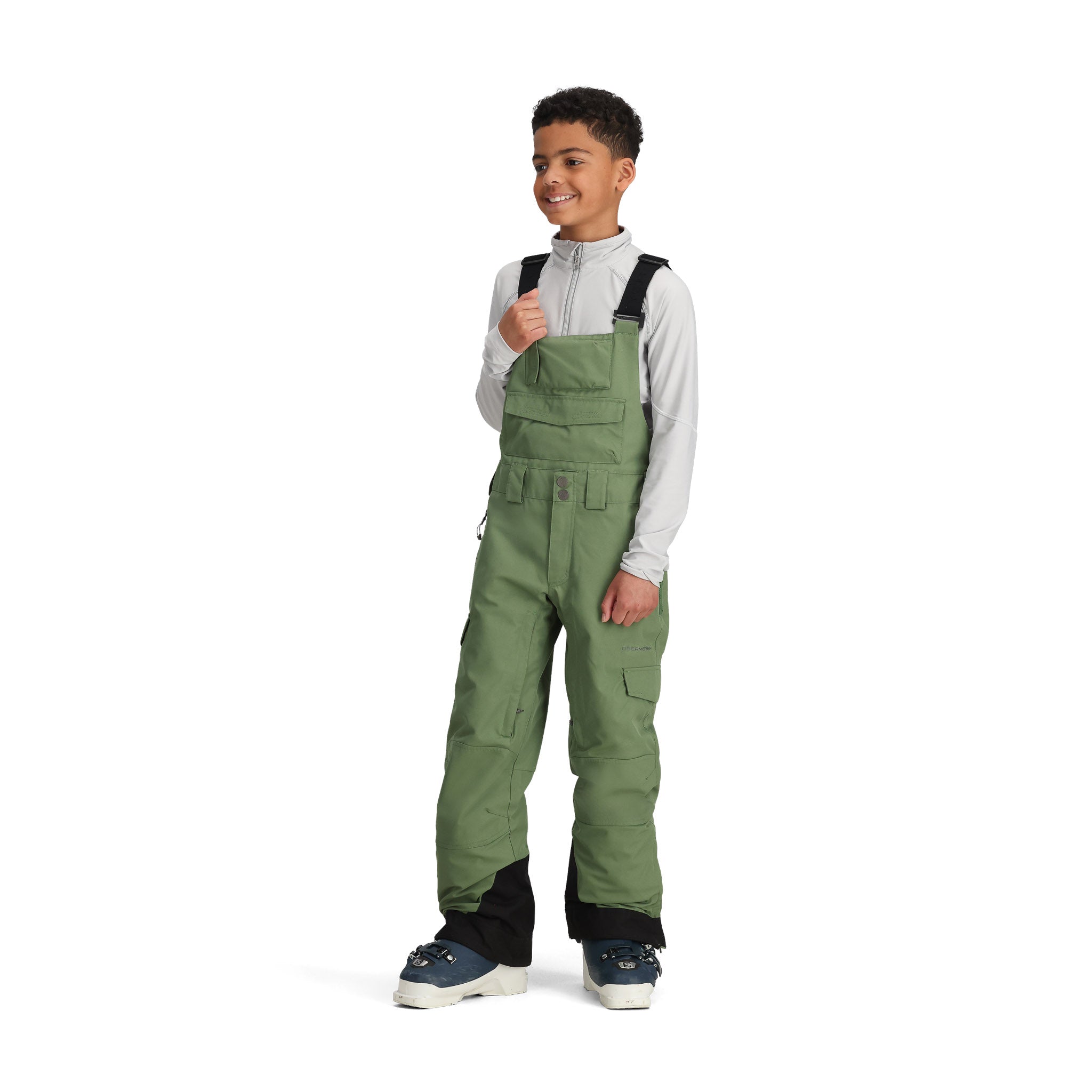 Obermeyer Junior's Carver Bib Pant 2025 - Olive green bib pants with adjustable straps and zippered pockets.
