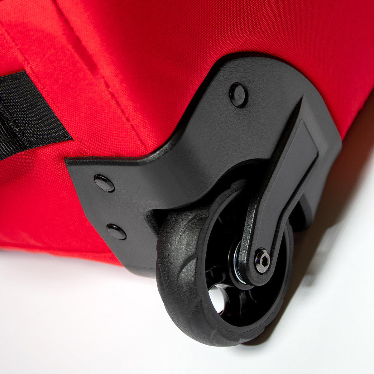 CAPiTA Explorer Wheeled Snowboard Bag - A red wheeled snowboard bag with black wheels and a black handle, featuring a rectangular shape with a flat top and rounded edges.