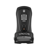 Union Women's Trilogy Snowboard Binding 2025 - A black snowboard binding with a white logo on top and a copper-colored metal piece in the middle.