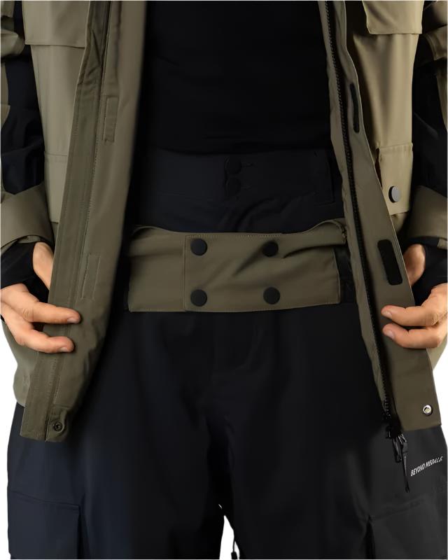 Beyond Medals Cargo Shell 2L Jacket 2025 - A khaki-colored jacket with a black zipper and two chest pockets, featuring a cargo pocket on one side.