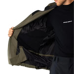 Beyond Medals Cargo Shell 2L Jacket 2025 - A dark olive green jacket with a black zipper and two zippered pockets on the front.