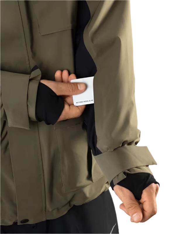Beyond Medals Cargo Shell 2L Jacket 2025 - A khaki green jacket with a black zipper and two chest pockets.