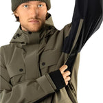 Beyond Medals Cargo Shell 2L Jacket 2025 - A khaki green jacket with a black zipper and two chest pockets.