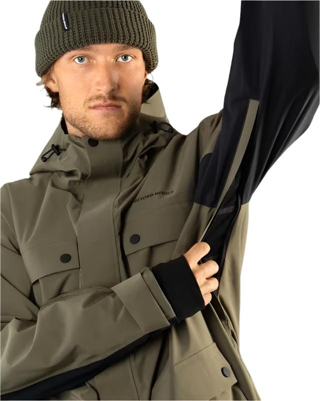 Beyond Medals Cargo Shell 2L Jacket 2025 - A khaki green jacket with a black zipper and two chest pockets.