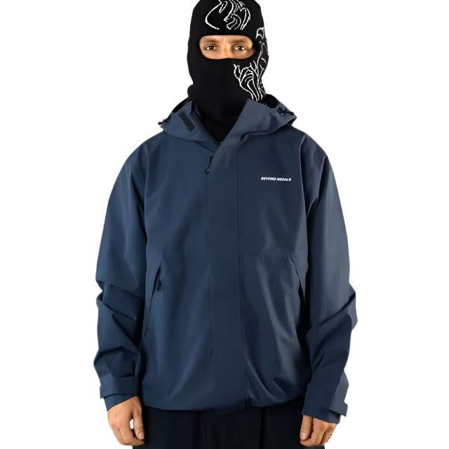 Beyond Medals The Jacket Shell 2025 - A black jacket with a white logo on the left chest and a zipper down the front.