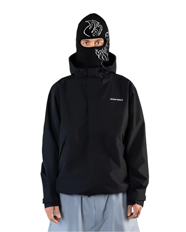 Beyond Medals The Jacket Shell 2025 - A black jacket with a white logo on the left chest and a zipper running down the middle.