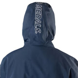 Beyond Medals The Jacket Shell 2025 - A navy blue jacket with a white logo on the left chest and a zipper running down the front.