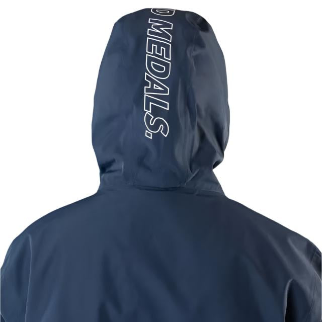 Beyond Medals The Jacket Shell 2025 - A navy blue jacket with a white logo on the left chest and a zipper running down the front.