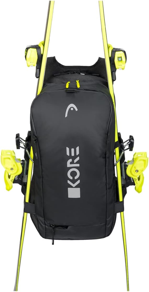 Head Kore Backpack 2023 - Black backpack with white logo on front, zippered pockets, and adjustable straps.