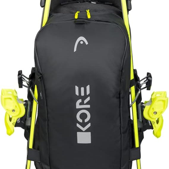 Head Kore Backpack 2023 - Black backpack with white logo on front, zippered pockets, and adjustable straps.