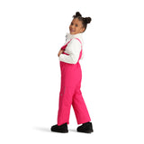 Obermeyer Junior's Snoverall Insulated Bib Pant 2025 - A pair of bright pink snow pants with a bib design, featuring silver zippers and adjustable straps on the shoulders.