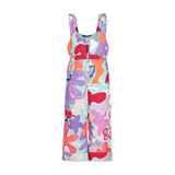 Obermeyer Junior's Snoverall Insulated Print Bib 2025 - A colorful overall with a print of abstract shapes in shades of purple, orange, and red on a light blue background.