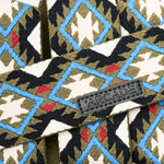 Arcade Twilight Belt 2025 - A black belt with a repeating pattern of white, blue, and red diamonds on a green background.