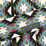 Arcade Twilight Belt 2025 - A black belt with a repeating pattern of white, blue, and red diamonds on a green background.