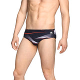 Speedo Infinite Pulse Brief Swimsuit - A black swimsuit with a red, white, and gray geometric pattern on the front.