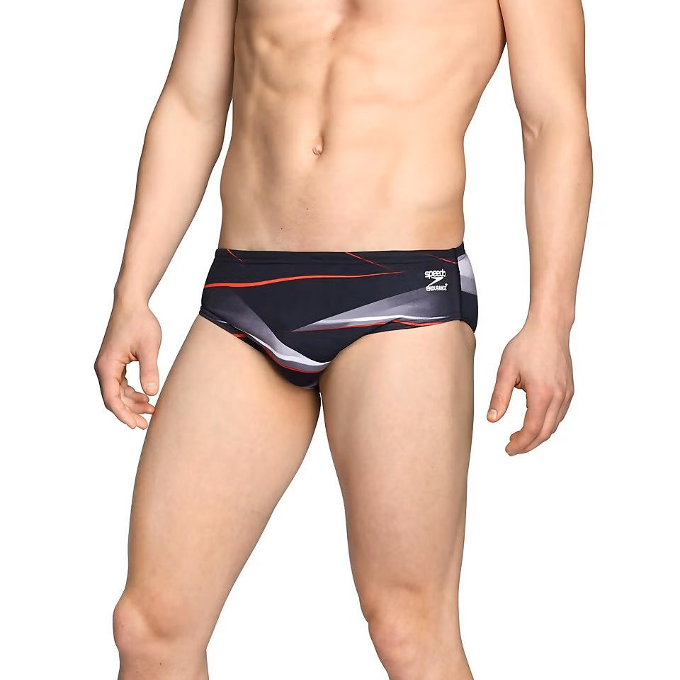 Speedo Infinite Pulse Brief Swimsuit - A black swimsuit with a red, white, and gray geometric pattern on the front.