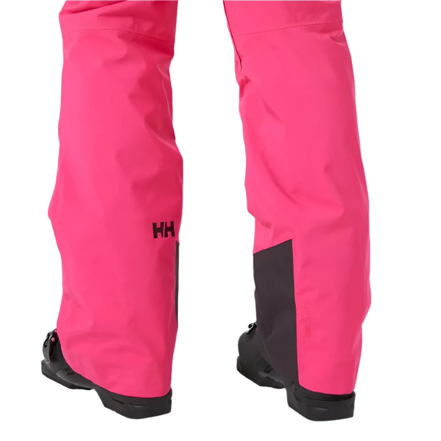 Helly Hansen Women's Legendary Insulated Pant 2025 - A pair of bright pink snow pants with a black logo on the left leg and black trim at the bottom.
