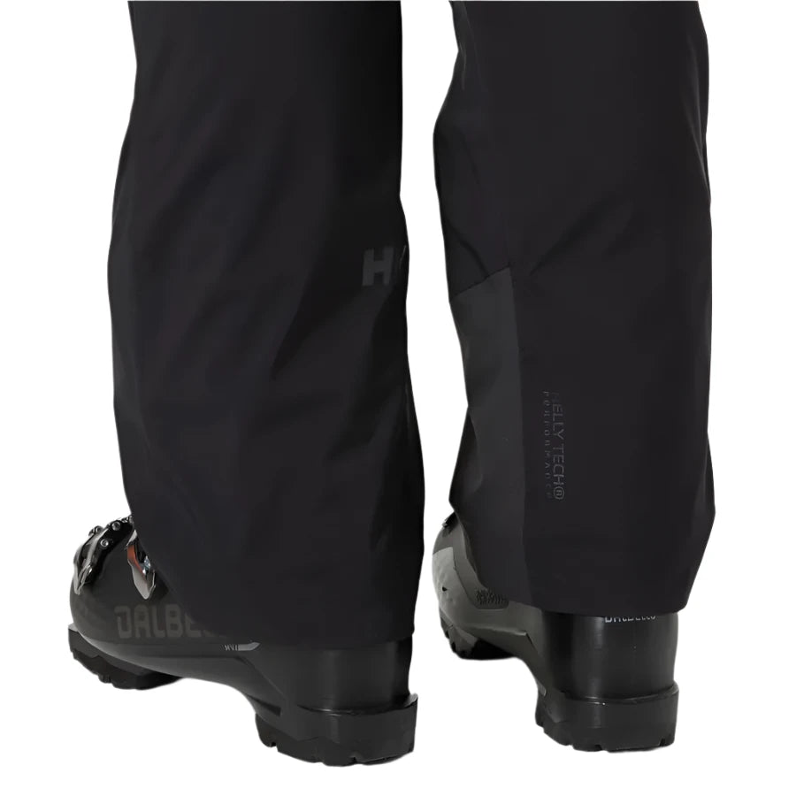 Helly Hansen Women's Legendary Insulated Pant 2025 - Black insulated ski pants with a subtle logo on the left thigh and zippered pockets at the back.