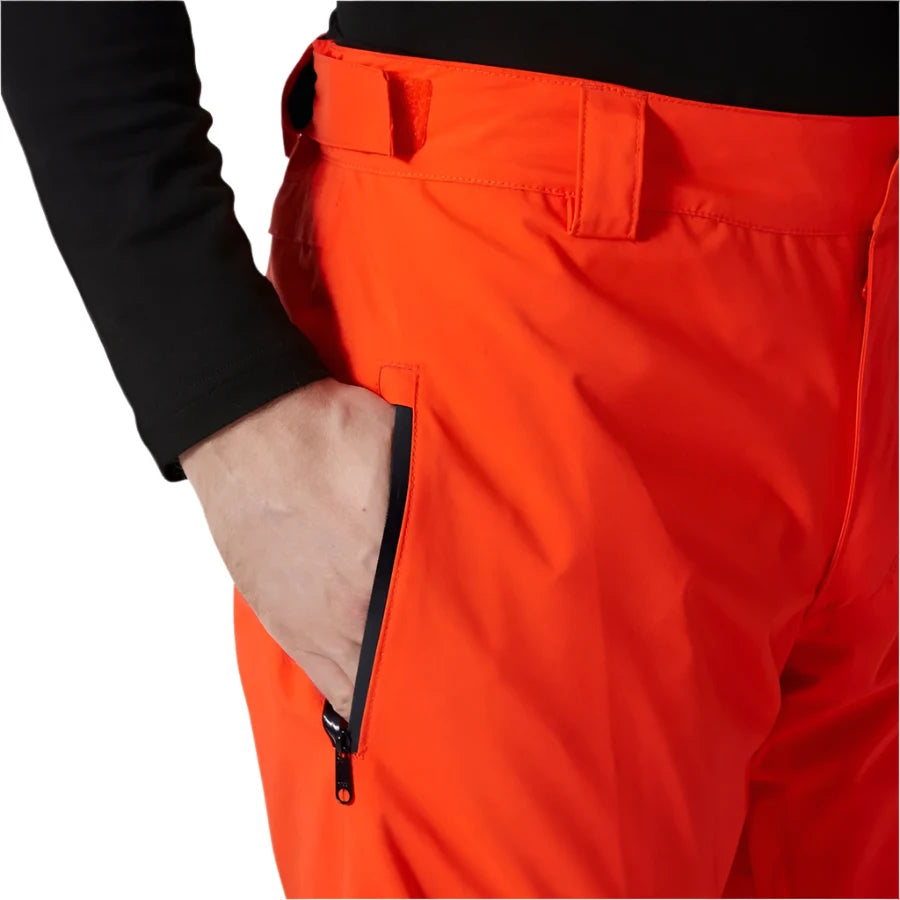 Hally Hansen Men's Legendary Insulated Pant - A pair of bright orange snow pants with a zippered pocket on the right side, featuring a black zipper and a small black pull tab.
