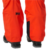 Hally Hansen Men's Legendary Insulated Pant 2025 - A pair of bright orange snow pants with a black logo on the left leg featuring the letters "HH" in bold, blocky font.