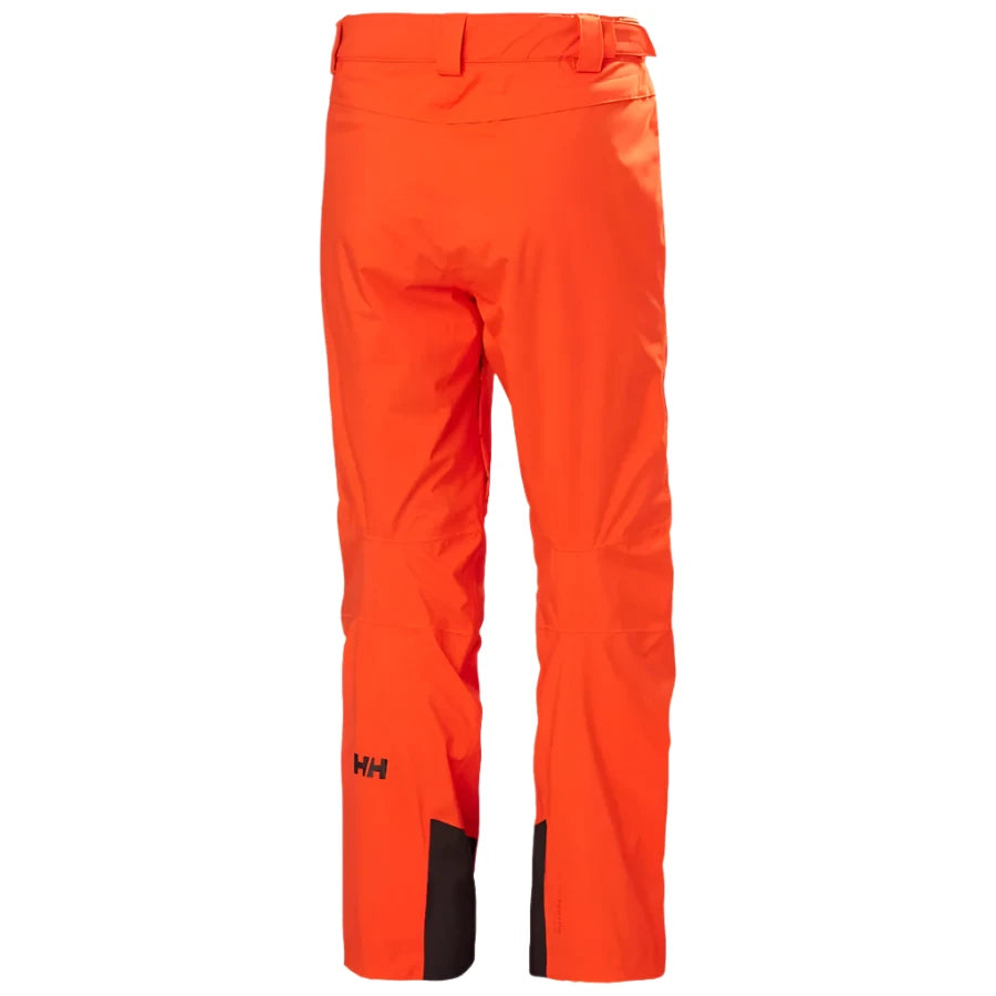 Hally Hansen Men's Legendary Insulated Pant 2025 - A pair of bright orange snow pants with a black logo on the left leg and a black belt loop on the right side.