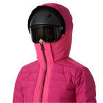 Helly Hansen Women's Avanti Insulated Jacket - A woman wearing a black helmet with a dark visor and a pink ski jacket with a high collar, zipped up to her chin.