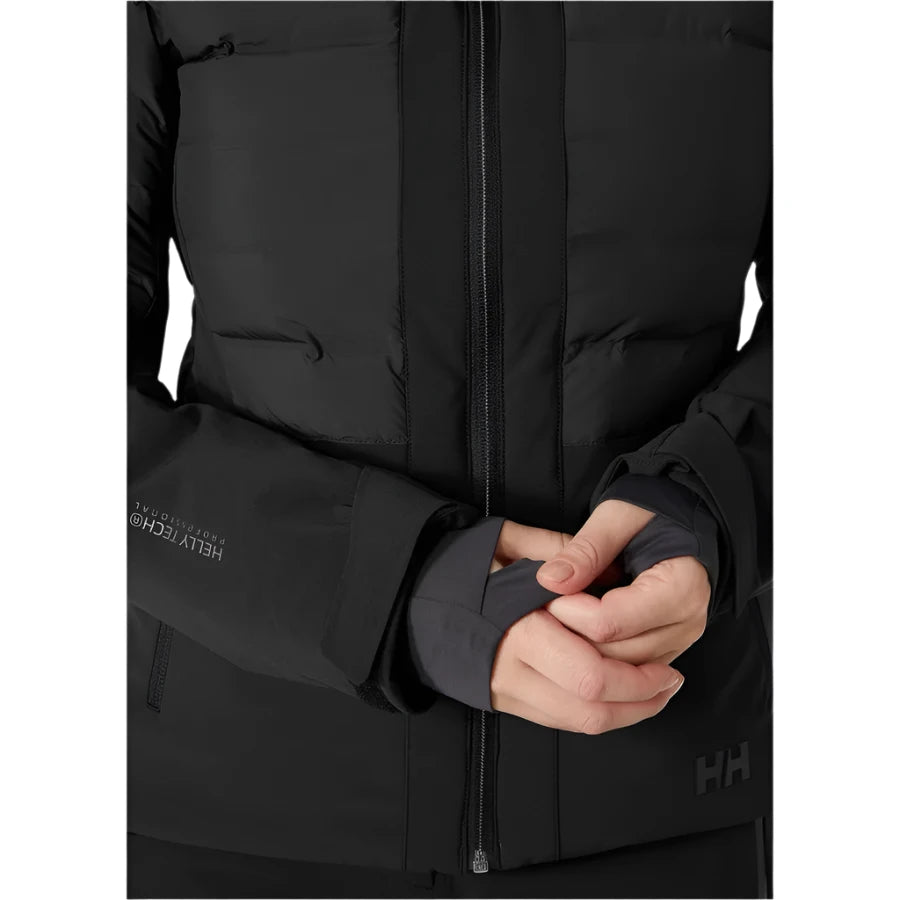 Helly Hansen Women's Avanti Insulated Jacket - A black insulated jacket with a zippered front and two side pockets, featuring a logo on the left chest.