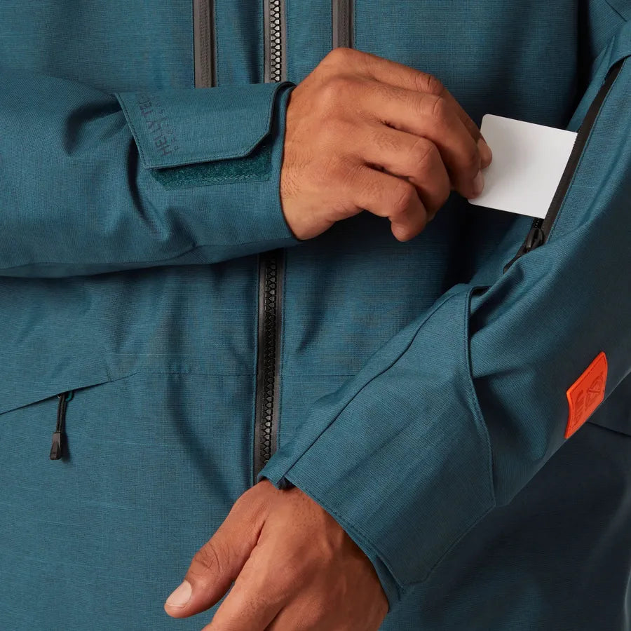 Helly Hansen Garbaldi 2.0 Insulated Jacket - A dark teal jacket with a zippered chest pocket and two zippered side pockets.