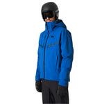 Helly Hansen Alpha Infinity Insulated Jacket 2025 - A blue jacket with a hood, featuring two zippered pockets on the front and a black zipper running down the middle.