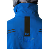Helly Hansen Alpha Infinity Insulated Jacket 2025 - A royal blue jacket with a black logo on the back and two zippered pockets on either side.