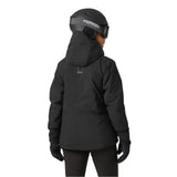 Helly Hansen Women's Edge 3.0 Insulated Jacket - A black jacket with a hood, featuring white lettering on the back and a zippered pocket on the side.