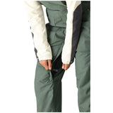 The 686 Women's Black Magic Insulated Bib 2024 is shown in a dark color with an insulated bib and adjustable cuffs.