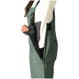 The 686 Black Magic Insulated Bib, available in women's sizes, showcases a black bib with a fully insulated design and adjustable straps at the front.