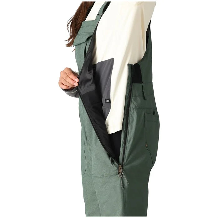 The 686 Black Magic Insulated Bib, available in women's sizes, showcases a black bib with a fully insulated design and adjustable straps at the front.