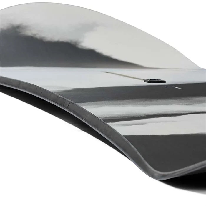 Burton Family Tree Alekesam Snowboard 2025 - A snowboard with a black base and white accents, featuring a distinctive tree-like design on its top surface.