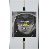 Burton Women's Story Board Snowboard - A black-and-white image of a woman wearing sunglasses and a hat, with the words "STORY BOARD" in yellow across her glasses.