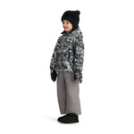 Obermeyer Junior's Ashor Insulated Jacket - A black and white patterned jacket with a hood, worn by a child standing in front of a plain background.