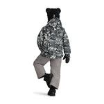Obermeyer Junior's Ashor Insulated Jacket - A black and white winter-themed patterned jacket with a hood, worn by a model on a solid background.
