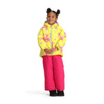 Obermeyer Junior's Ashor Insulated Jacket - A bright yellow jacket with a repeating pattern of pink and blue cartoon deer, featuring a hood and zipper closure.
