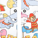 Stance Disney 100 Dumbo By Travis Millard Crew Sock - A pair of crew socks featuring an illustration of Dumbo flying with a circus tent in the background.