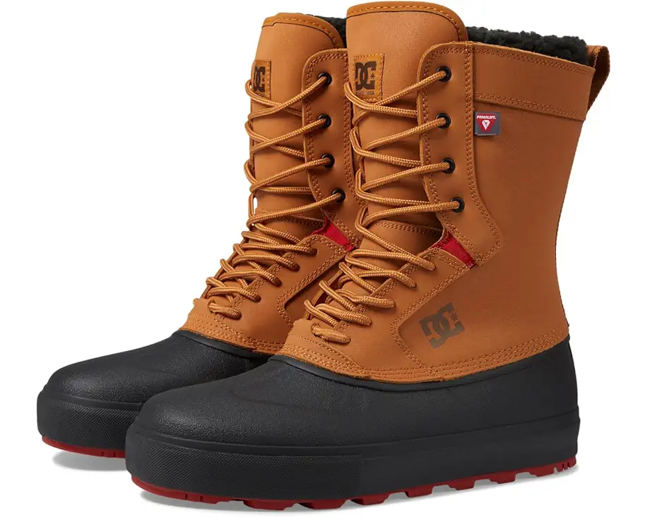 DC Reach Insulated Water Resistant Boot 2024 - A pair of tan boots with black soles and red accents, featuring a DC logo on the side.
