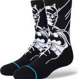 THE BATMAN KIDS CREW SOCK 2022 - A pair of black crew socks with a white Batman logo on the top portion.