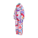 Obermeyer Junior's Quinn Insulated One-Piece Suit 2025 - A white snowsuit with a colorful abstract pattern of pink, purple, blue, and orange shapes.