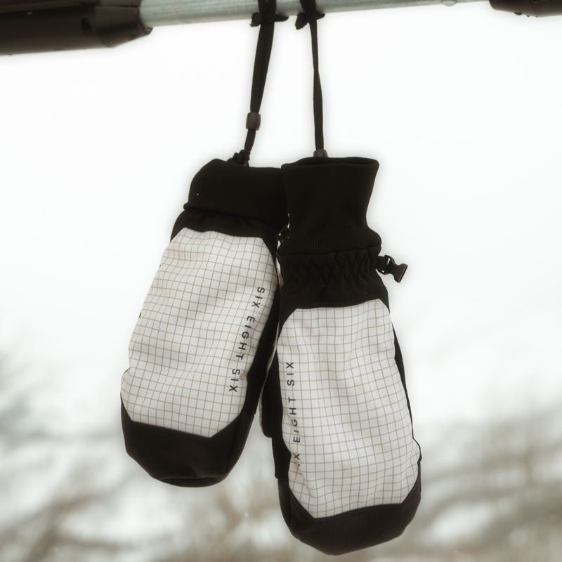 Black and light grid insulated mitts hanging with adjustable wrist straps