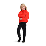 Obermeyer Junior's Ultra Gear Zip Top 2025 - A young girl with blonde hair, wearing a red zip-up jacket and black pants.