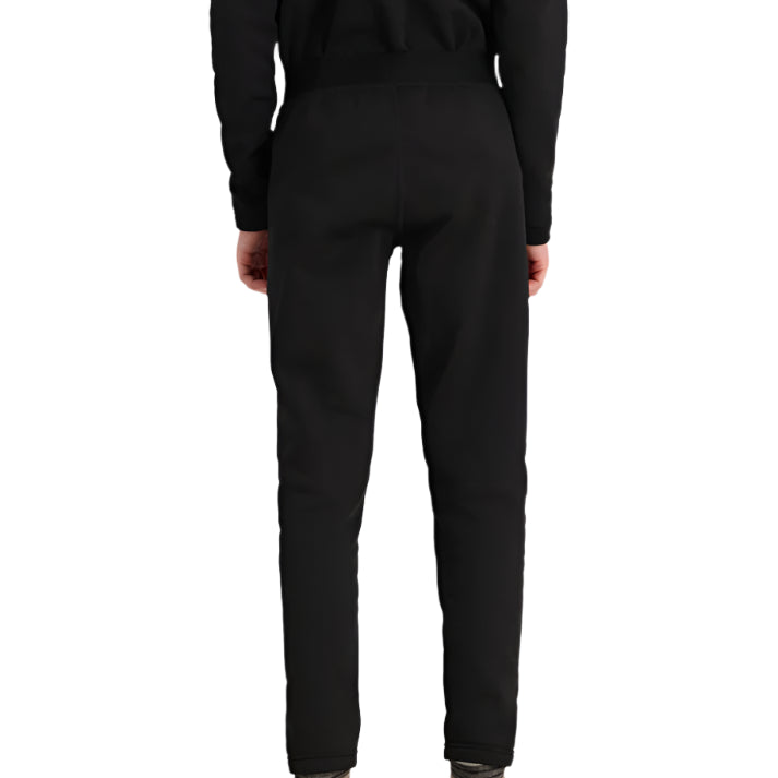 Obermeyer Junior's UltraGear Bottom 2025 - Black snow pants with a subtle white stripe on the left leg, worn by a model from behind.