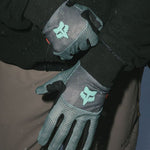 Teal-and-black ski gloves with teal bull logo patch and grippy fingertip design