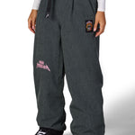 Women's dark gray wide-leg shell pants with elastic waistband and side graphics
